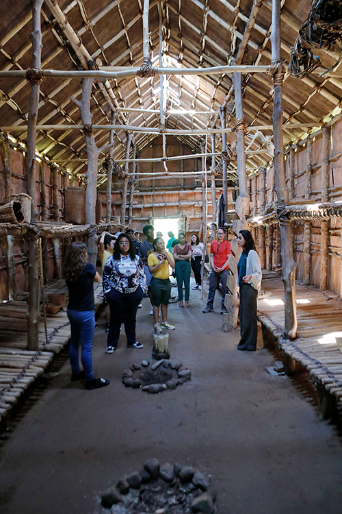 students looking up at the wooden roof of an 