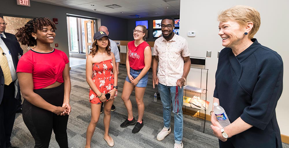 group of students speaking with President Mangelsdorf