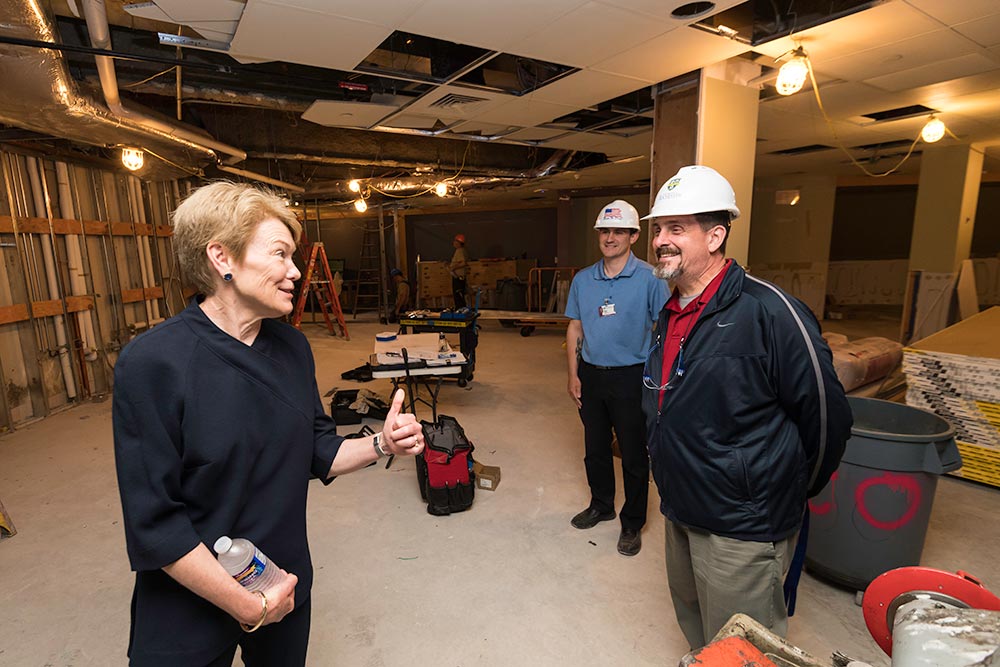 Sarah Mangelsdorf greets workers in hard hats.