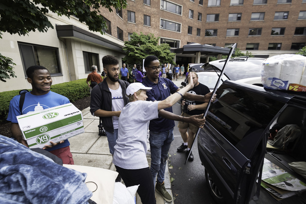 President Mangelsdorf and SA president Jamal Holtz wave toward a family's car.