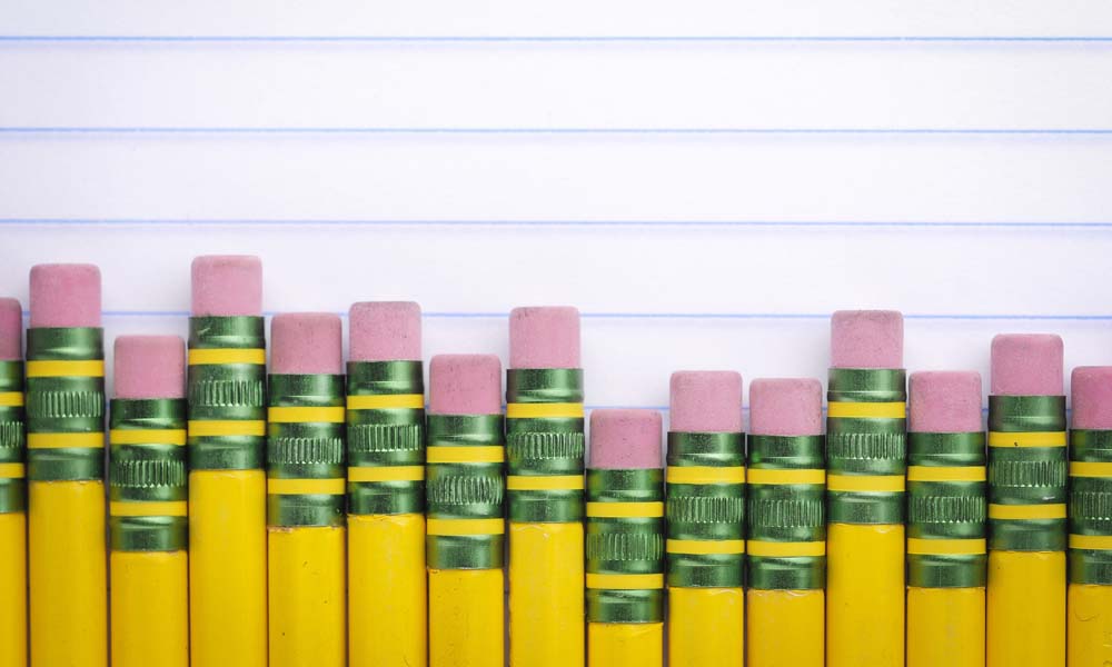 Row of number 2 yellow pencils atop lined paper to illustrate that not all charter schools are created equal.