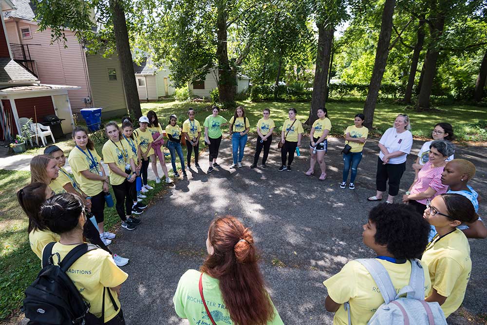 large group of students in matching shirts standing in a circle