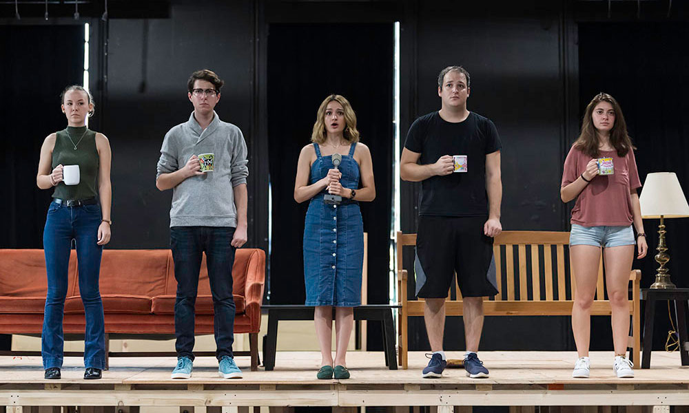 Feature image five actors stand on a stage
