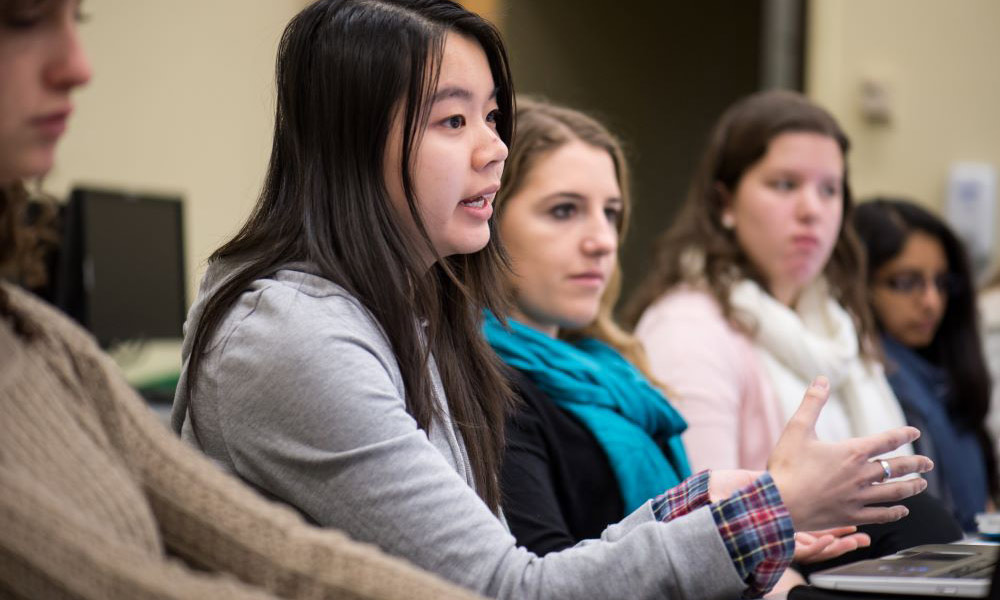 Feature image students speaking during a seminar class
