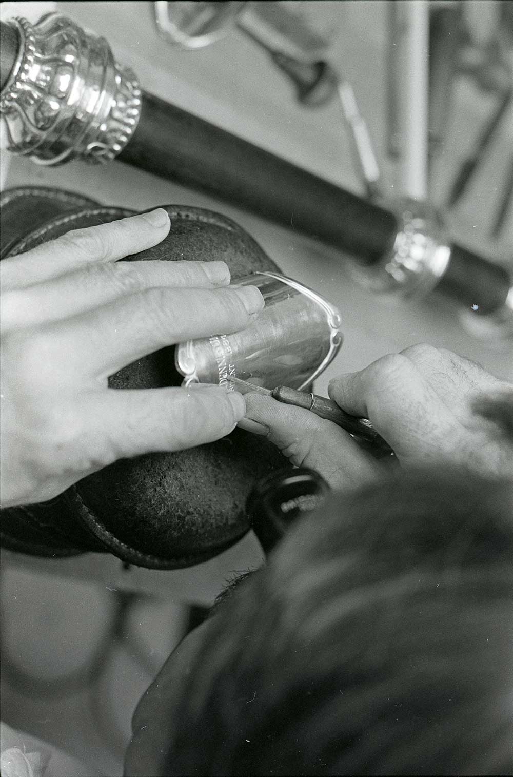 close-up photos of hands engraving a mace
