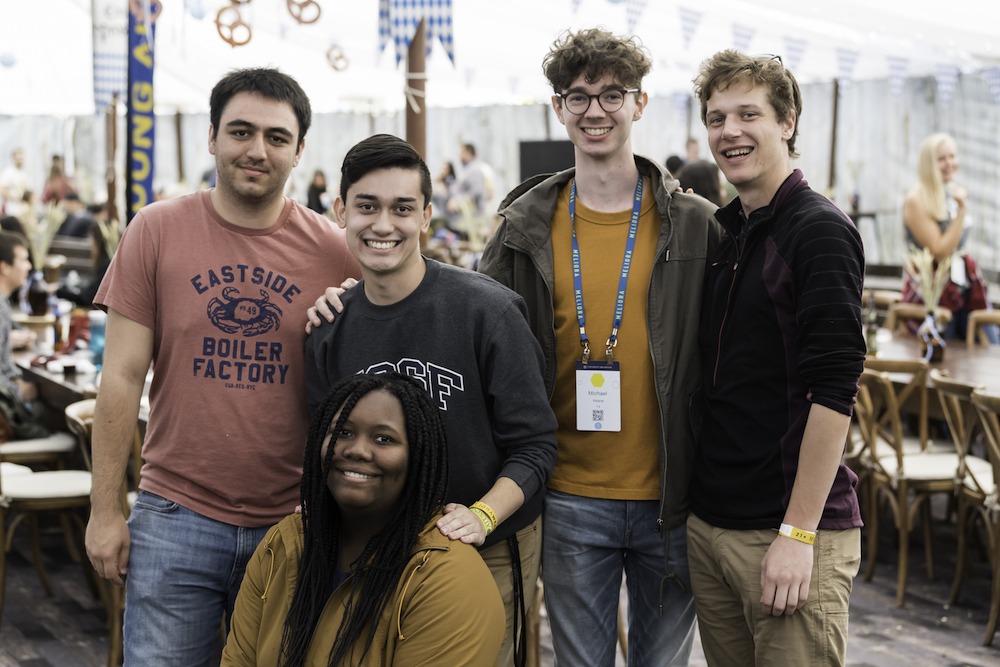 group of alumni and student posing for a photo