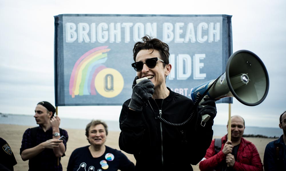 Feature image Masha Gessen speaks into a megaphone during the LGBT Pride March.