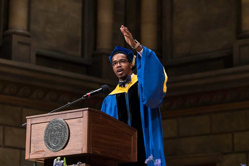 Jamal Holtz speaks at podium.