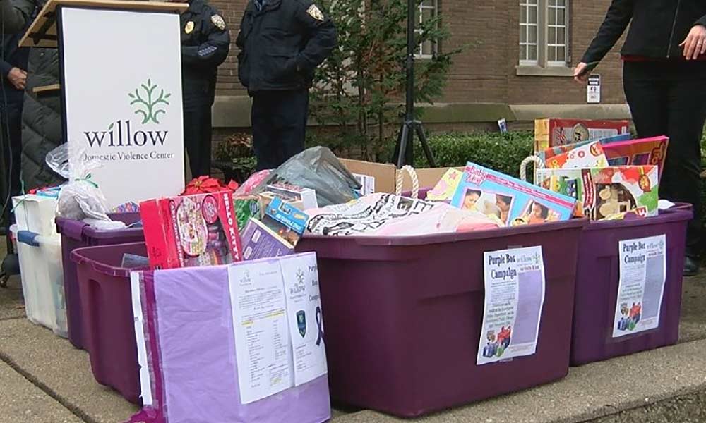 row of large, purple containers each filled with toys and gifts.