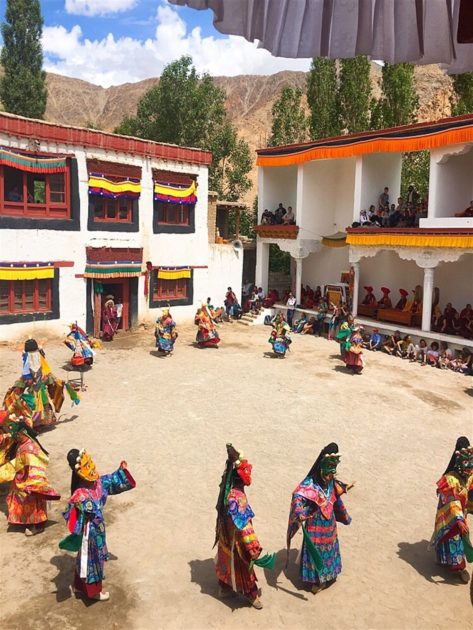 masked monks wearing colorful dresses performing dances