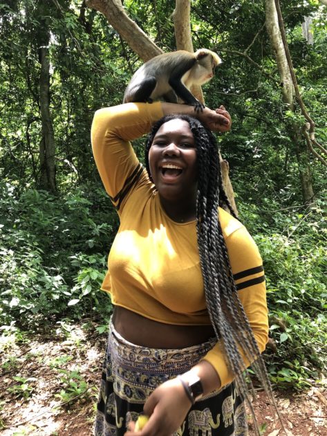 monkey sits on a woman's head