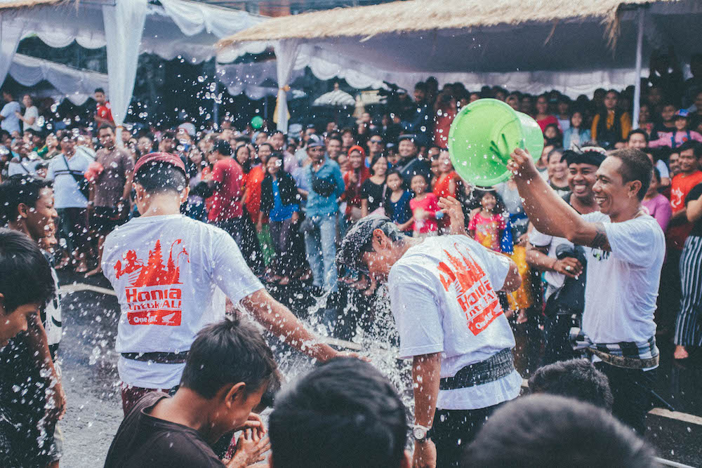 buckets of water are dumped on people at festival
