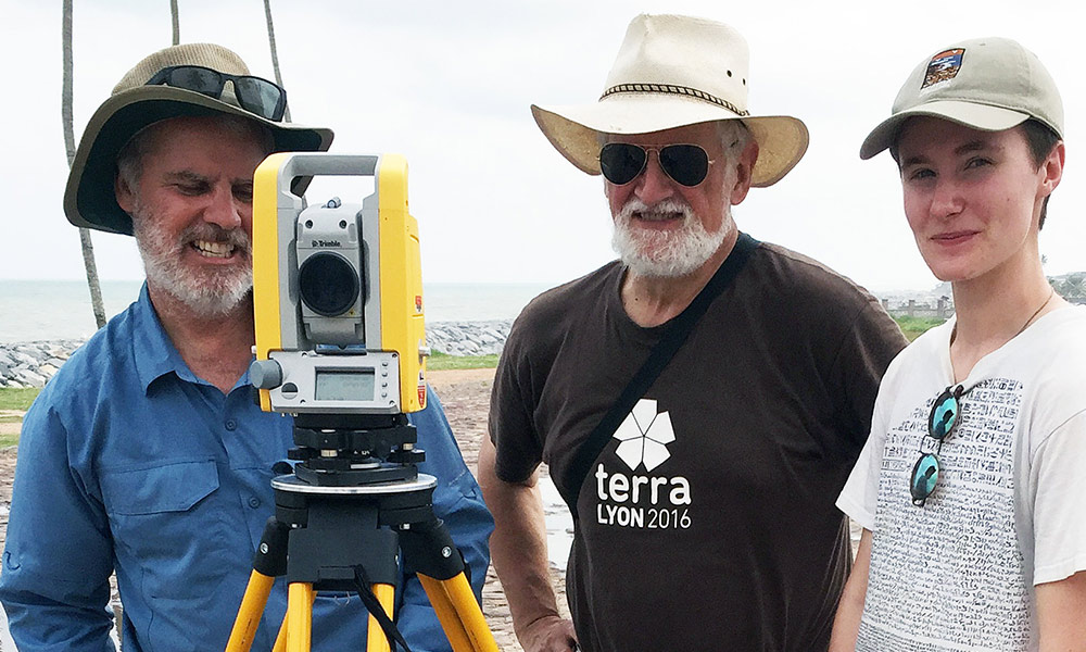 Feature image three people pose for a photo with a surveyor tool.