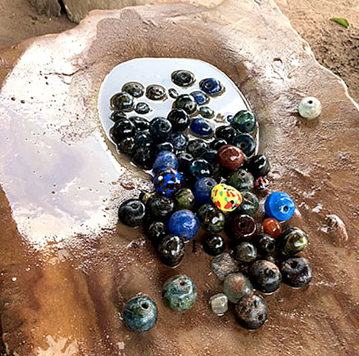 colorful beads on a stone structure.