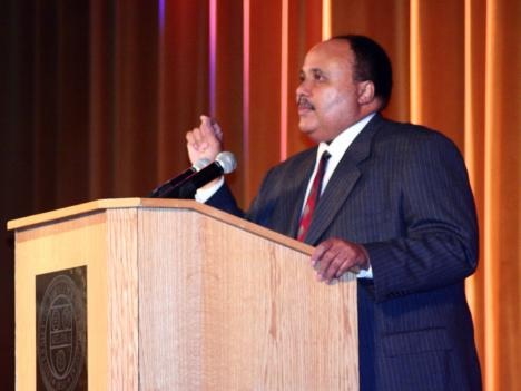 Martin Luther King III speaking at a podium during the 2006 Martin Luther King Jr. Commemorative Address at URochester.