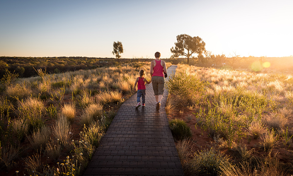 woman and child walking down a path