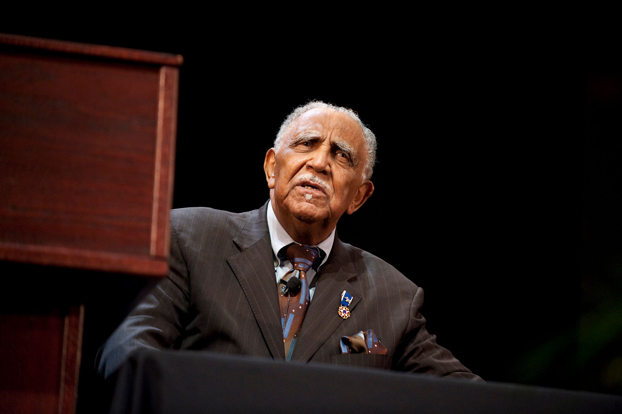 Joseph Lowery just to the side of a podium during the 2010 Martin Luther King Jr. Commemorative Address at URochester.