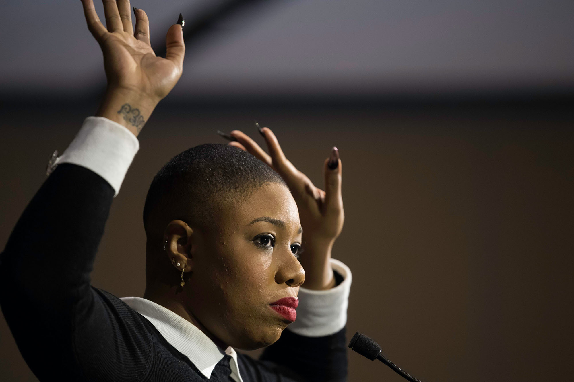 Close-up of Symone Sanders with her hands up around her face during the 2019 Martin Luther King Jr. Commemorative Address at URochester.