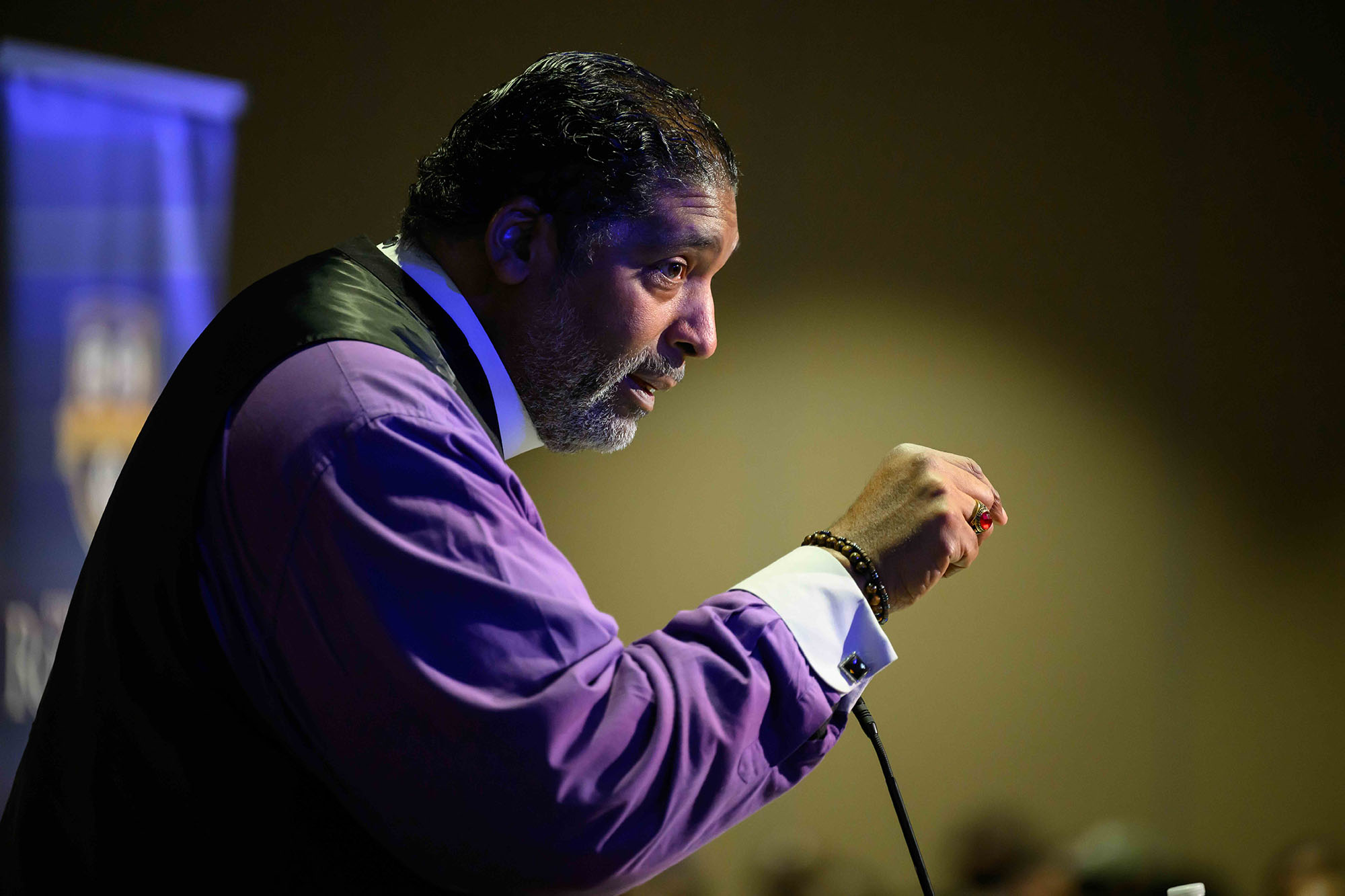 The Rev. Dr. William J. Barber II seen in side profile while speaking at a podium during the 2026 Martin Luther King Junior Address at URochester.