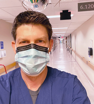 nursing student in mask and scrubs.