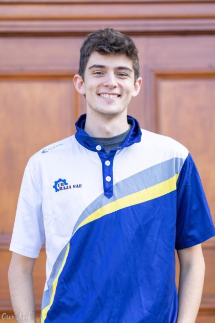 Ethan Fahnestock smiling, in UR SAE Baja team polo shirt.