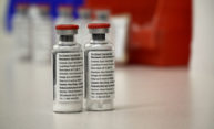 Two vials sit next to each other on lab table.