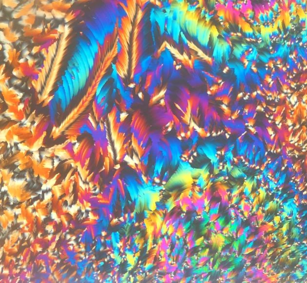 Bursting array of bright turquoise, blue, magenta, yellow, green, red, and orange brush strokes.