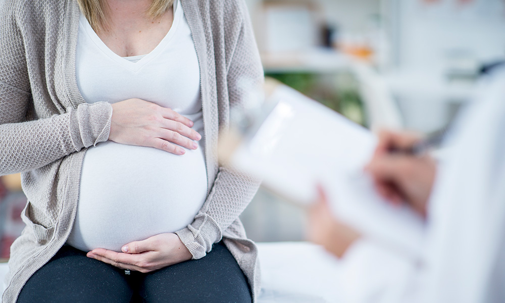 pregnant woman cradling belly