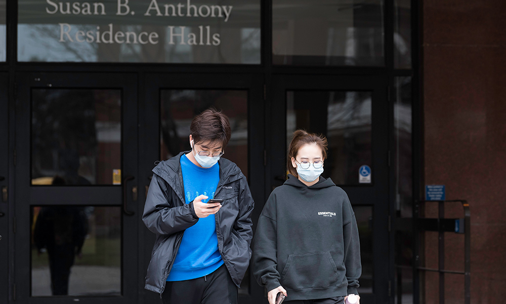 Feature image students in masks by residence hall