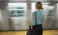 stock image of woman waiting near moving train illustrates causal inference.