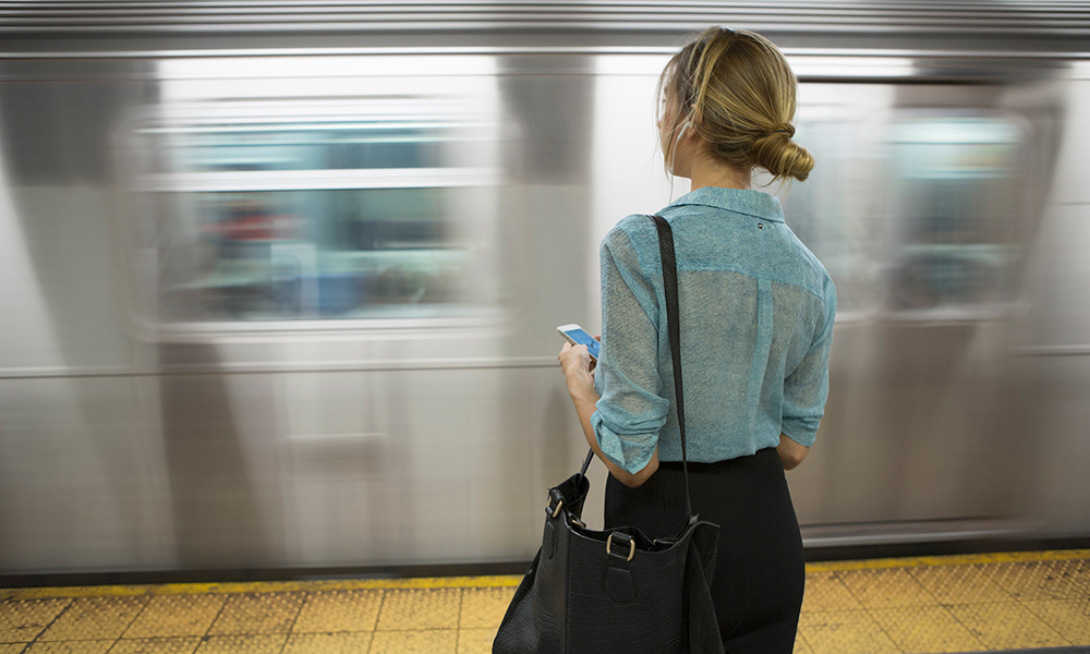 stock image of woman waiting near moving train illustrates causal inference.
