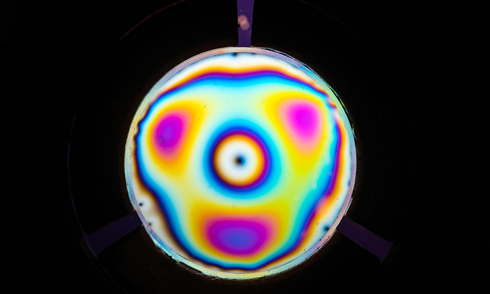 Blurry image of molecules in circular frame.