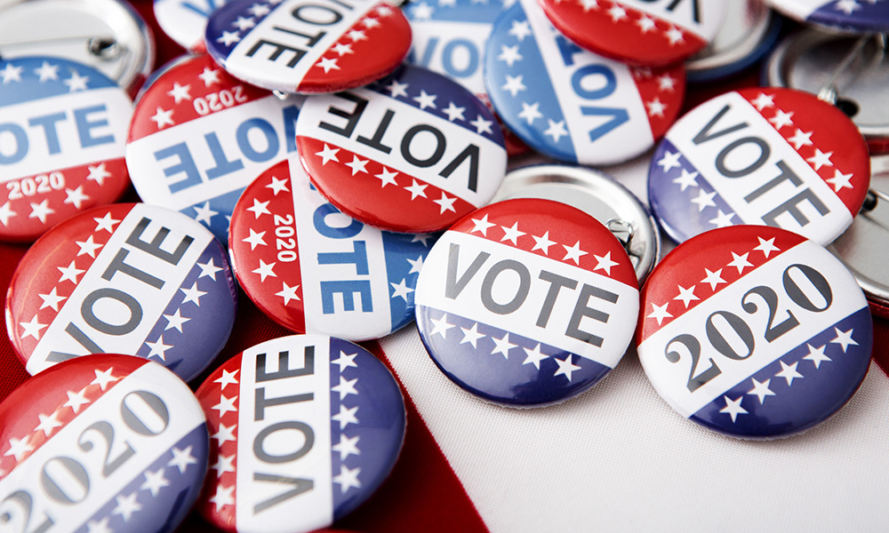 Pile of political buttons that say 