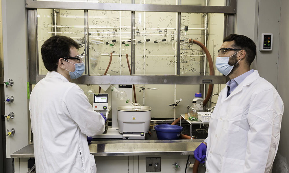 Feature image two people wearing lab coats standing in a chemistry lab