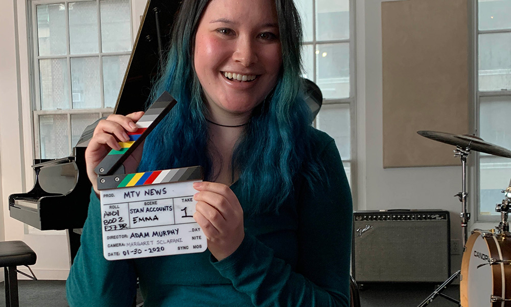 Feature image Emma Chang holding a film slate marker labeled MTV NEWS.