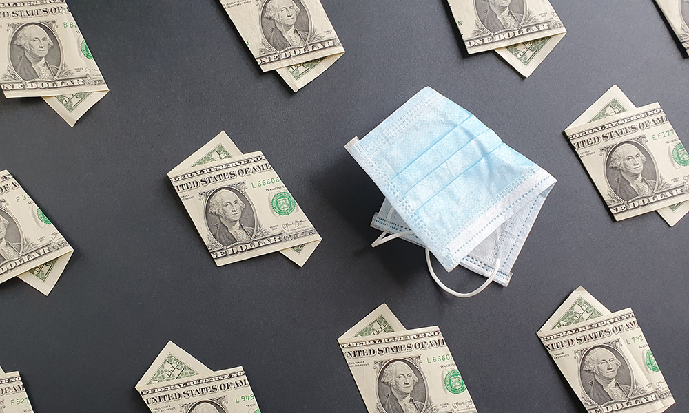 Feature image one dollar bills near folded surgical mask