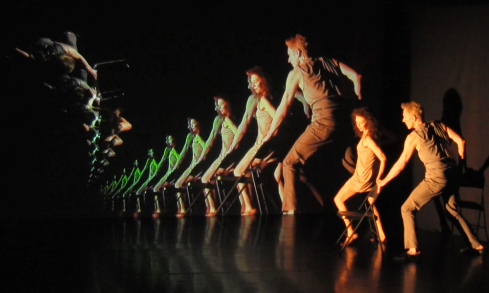 Feature image Composite image shows multiple images of a man and woman dancing with a chair.
