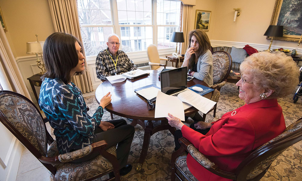 Students and seniors around table.