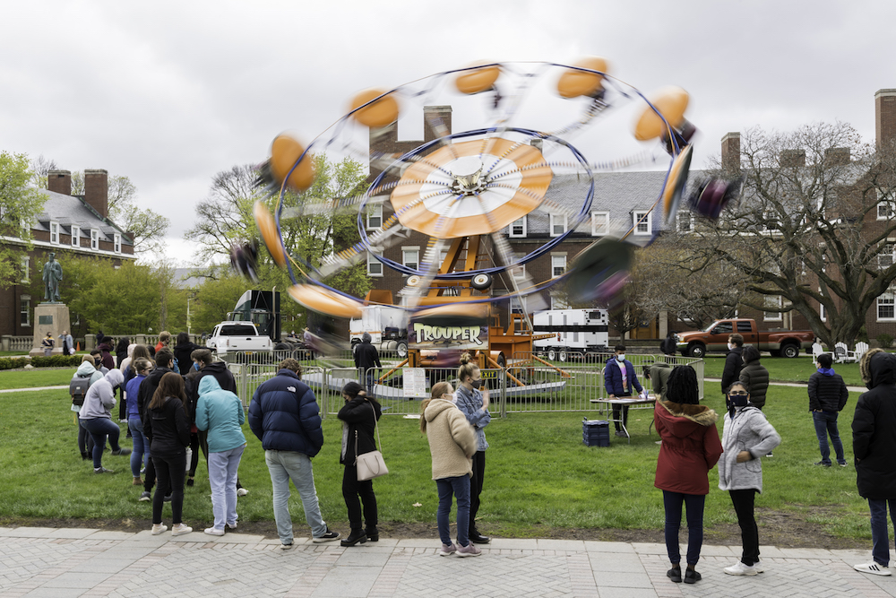 students waiting for a spinning amusement ride