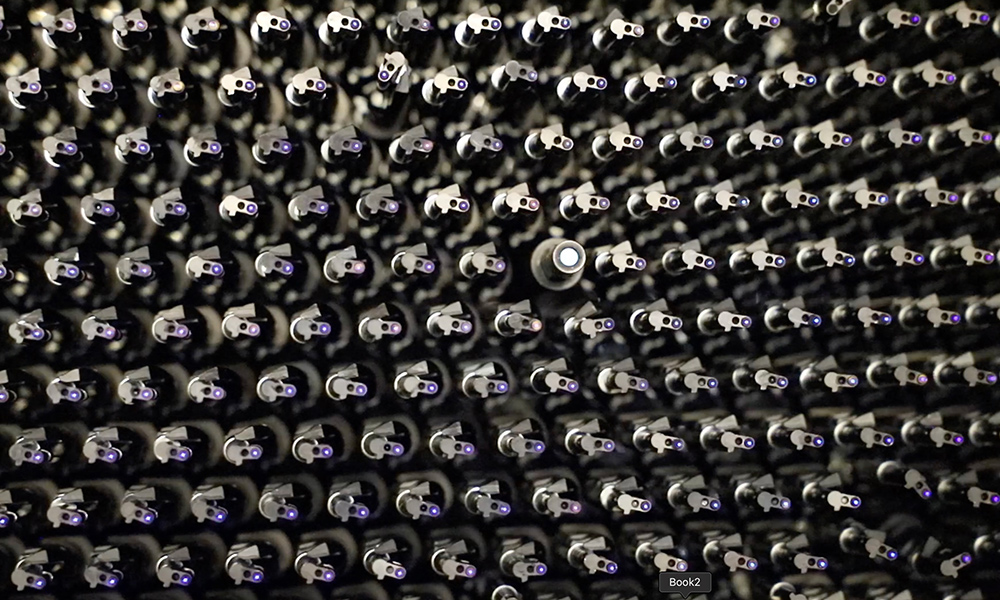 Close-up of dozens of optical fibers in a grid.