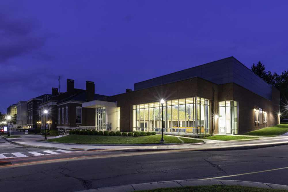 Jay Yan's mural seen from Wilson Boulevard at twilight inside the Sloan Center.