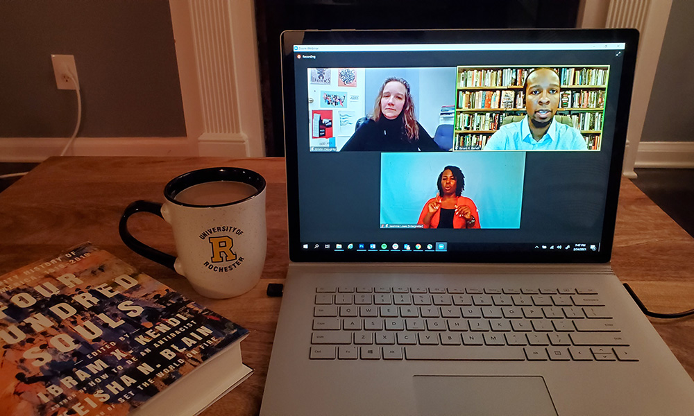 a laptop featuring zoom screen featuring two speakers and an interpreter