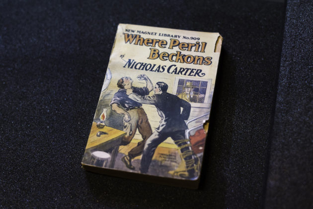 book cover shows drawing of man punching another man