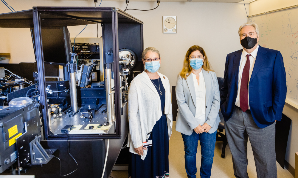 Krystel Huxlin, Susana Marcos, and David Williams in masks stand for a portrait in a lab.