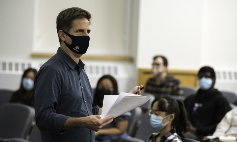 Jason Middleton in a mask teaches his film class.