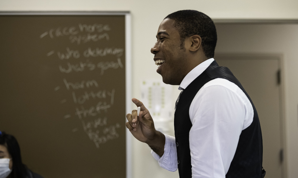 Will Bridges in profile with a blackboard in the background.