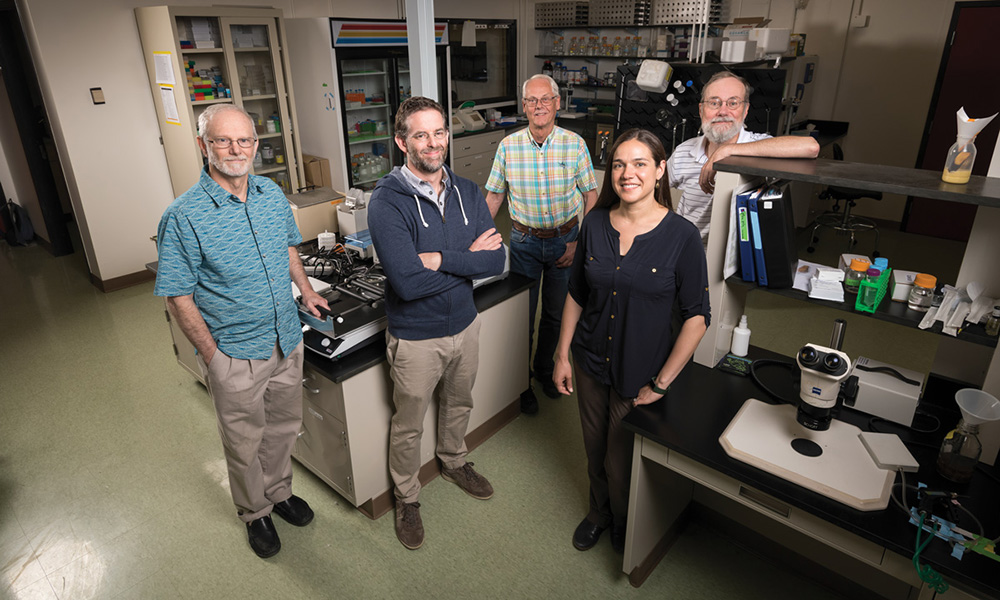 group of researchers standing in a lab.