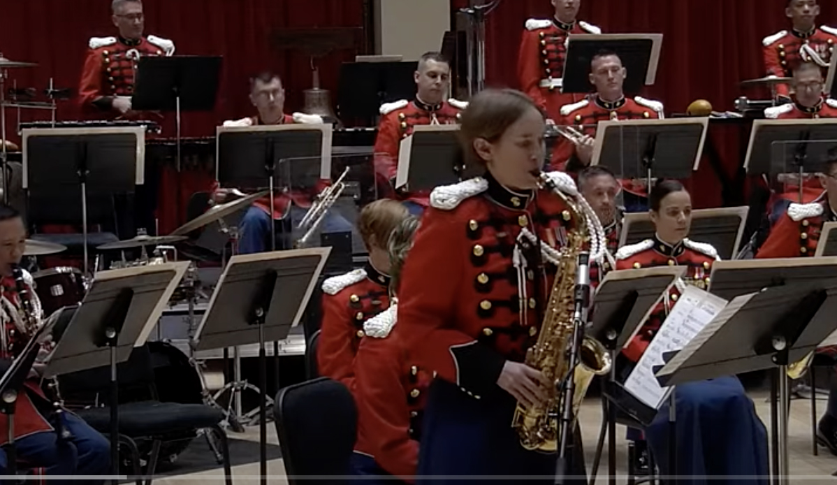 Perry playing saxophone as soloist with Marine Band.
