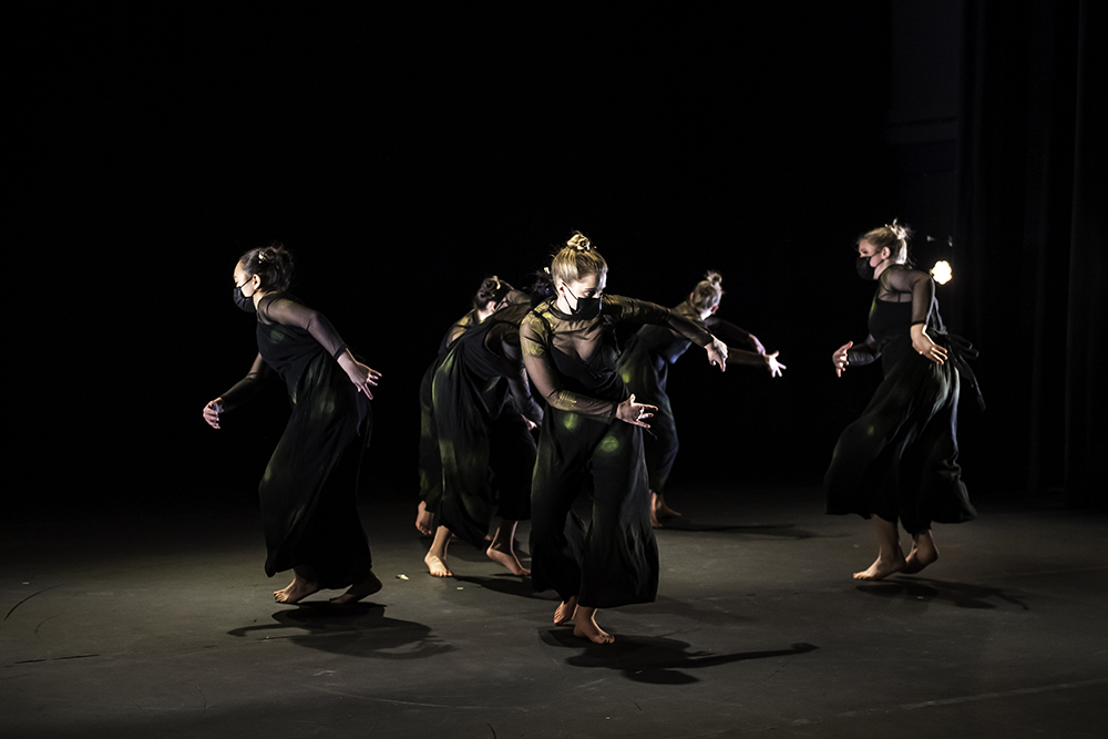 group of six students dancing in a circle