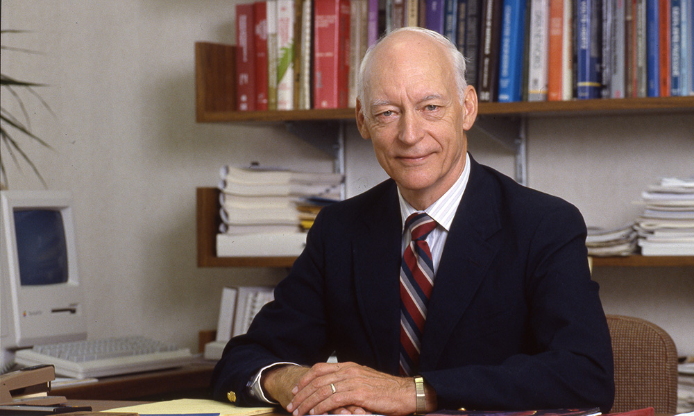 portrait of bruce arden seated at desk